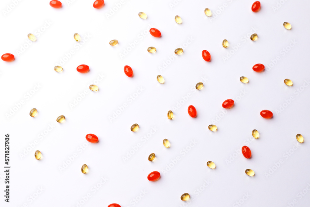 Vitamins, pills scattered on a white background Vitamins, pills scattered on a white background
