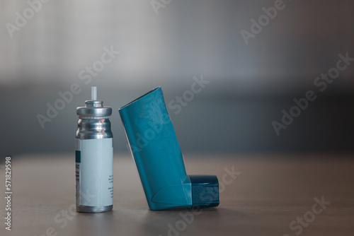 Blue inhaler, also known as pump or allergy spray, medical device for asthma or COPD patients. photo