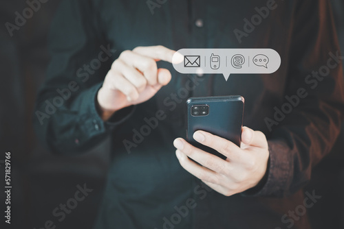 Businessman pressing telephone, Contact us or Customer support hotline people connect. Businessman using smart phone and touching on virtual screen contact icons 