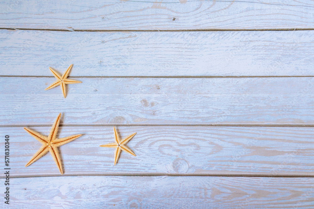 Sea stars. Summer nautical background - stars on wooden blue background Sea stars. Summer nautical background - stars on wooden blue background