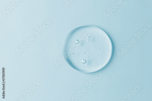Cosmetic lotion transparent gel drop texture, on blue background
