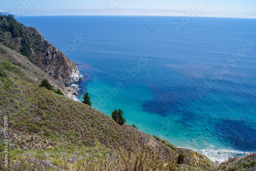 Panoramic view of the rugged coastline of Big Sur with Santa Lucia Mountains along famous Highway 1, Monterey county, California, USA, America. Road trip on overcast summer day at seaside.