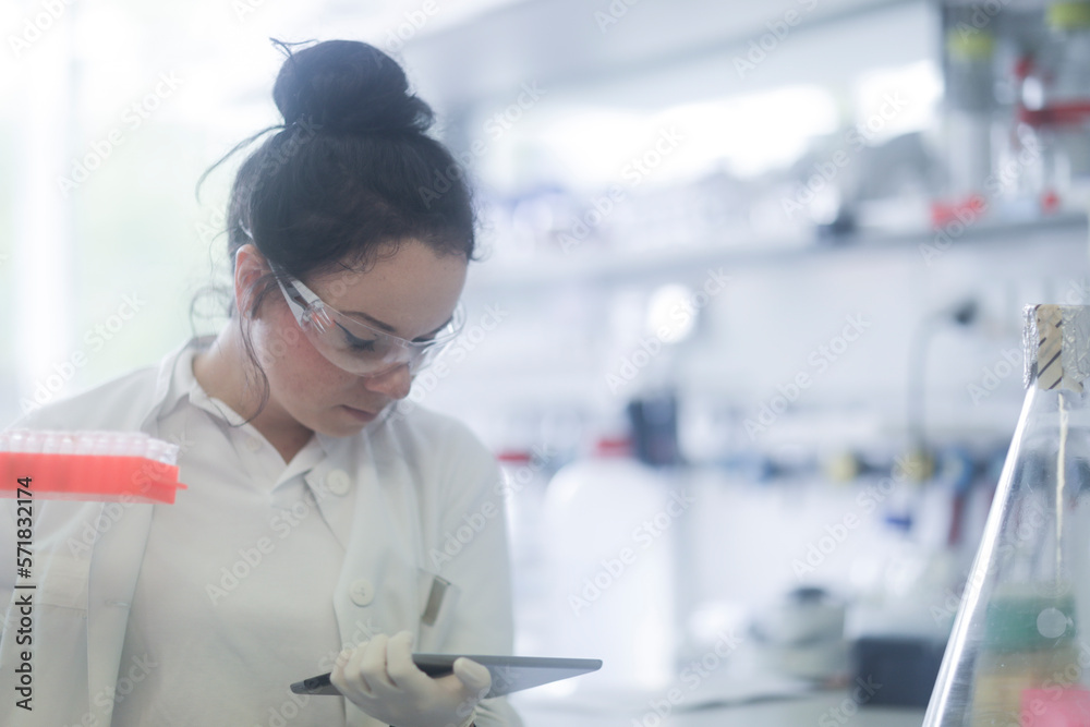 young scientist female with tablet in a laboratory young scientist female with tablet in a laboratory