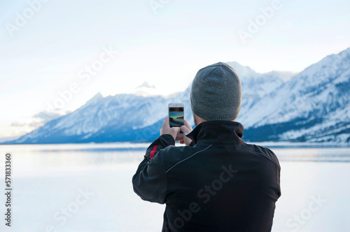 Wallpaper Mural Man taking a photo with a smart phone of Jackson Lake and Teton Range Torontodigital.ca