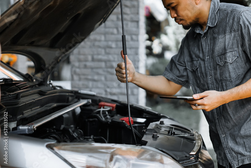 Auto mechanic working in garage. Repair service. 