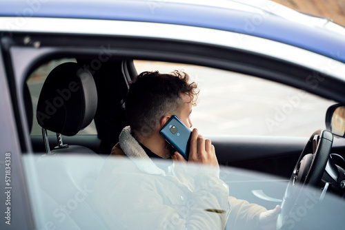 Person using his smartphone in his car photo