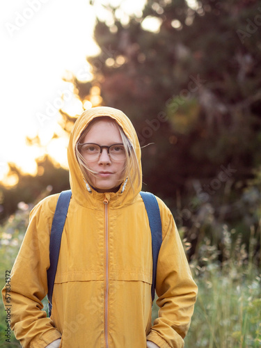 Portrait of tween outdoors looking at camera wearing glasses photo