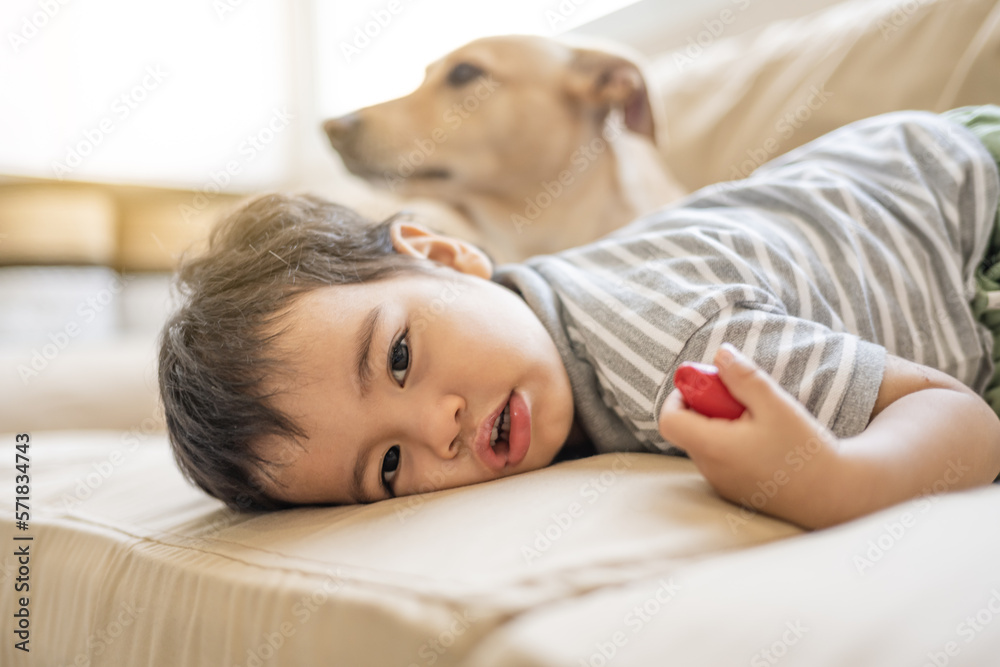 Latino boy with his mixed-breed puppy in his living room Latino boy with his mixed-breed puppy in his living room