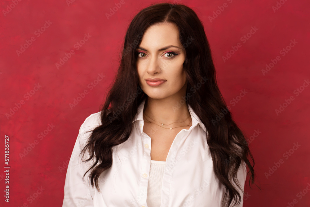 A long-haired, self-confident brunette in a white shirt