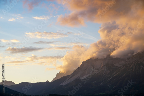 Colorful sunset with some clouds over the mountains. Wonderful scenery with copy space for text