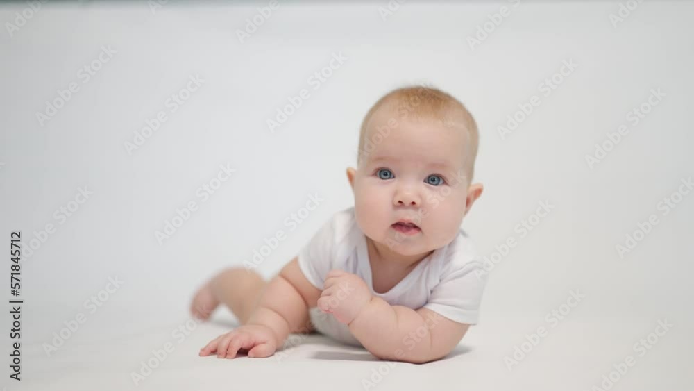 Portrait of a contented baby on a white background, concept stages of becoming a human being in a newborn state Portrait of a contented baby on a white background, concept stages of becoming a human being in a newborn state