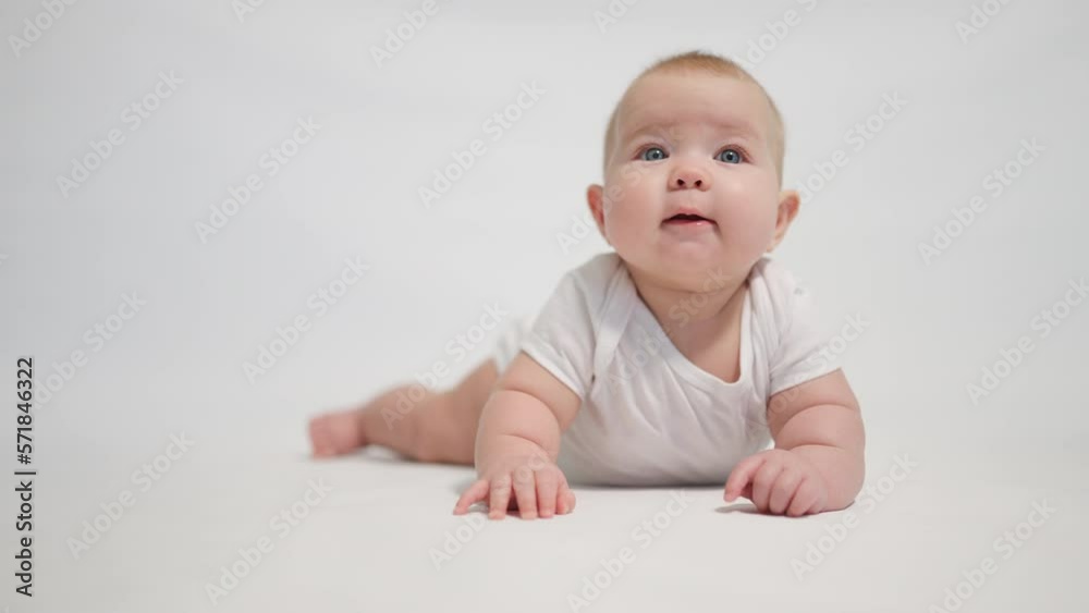 The baby begins to try to crawl. one of the stages of development of the child to uprightness The baby begins to try to crawl. one of the stages of development of the child to uprightness