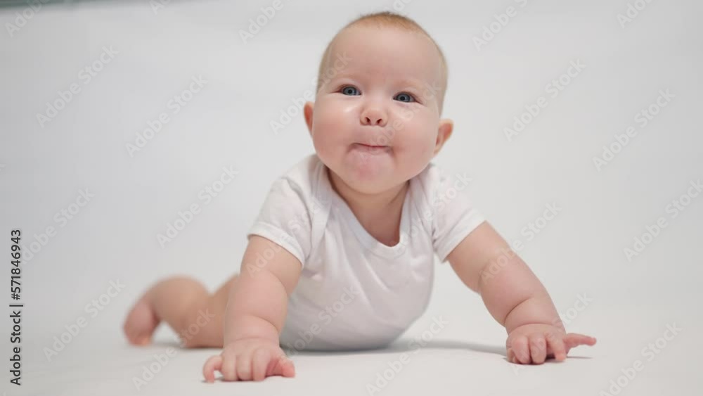 The baby close-up begins to rise in his arms. one of the stages of child development The baby close-up begins to rise in his arms. one of the stages of child development
