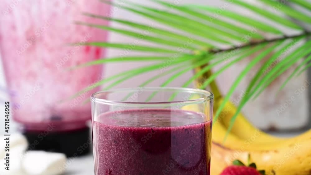 Berry smoothie in a glass. Strawberry, banana, blueberry thick smoothie. Berry smoothie in a glass. Strawberry, banana, blueberry thick smoothie.
