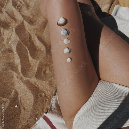 Φωτογραφία Beautiful young woman sunbathes on the beach