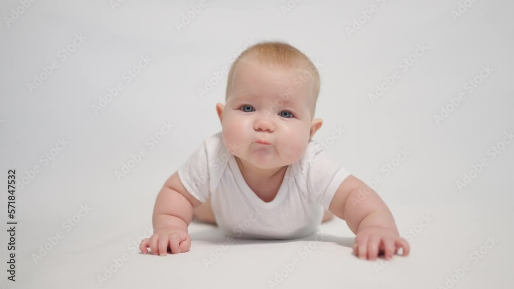 Portrait of a contented baby on a white background, concept stages of becoming a human being in a newborn state Portrait of a contented baby on a white background, concept stages of becoming a human being in a newborn state