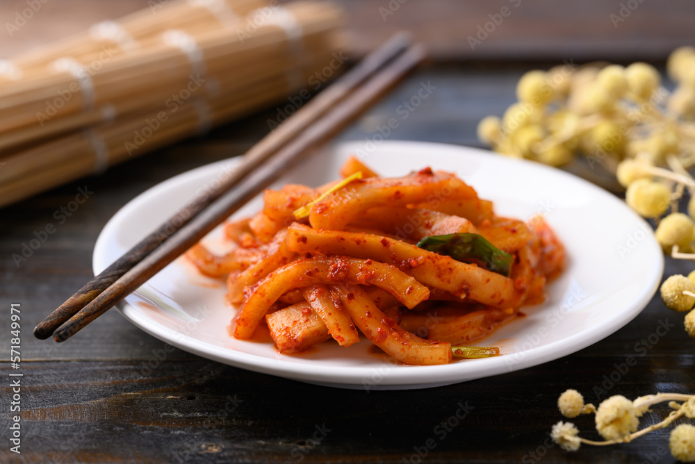 Kimchi radish on wooden background, Korean food homemade side dish Kimchi radish on wooden background, Korean food homemade side dish