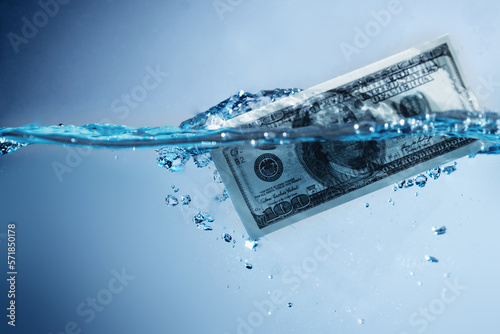 Money laundering. US Dollar banknotes in the water. Copy space. photo
