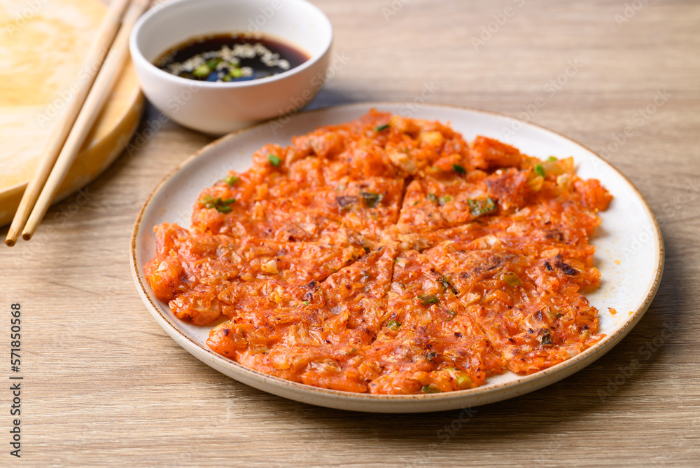 Kimchi pancake (Kimchi jeon or kimchi buchimgae) on plate eating with soy dipping sauce, Korean food Kimchi pancake (Kimchi jeon or kimchi buchimgae) on plate eating with soy dipping sauce, Korean food