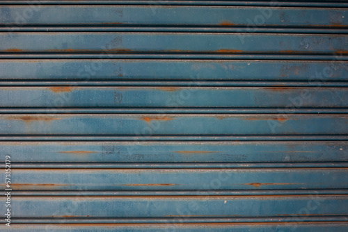 Background texture of a blue rusty roller door.