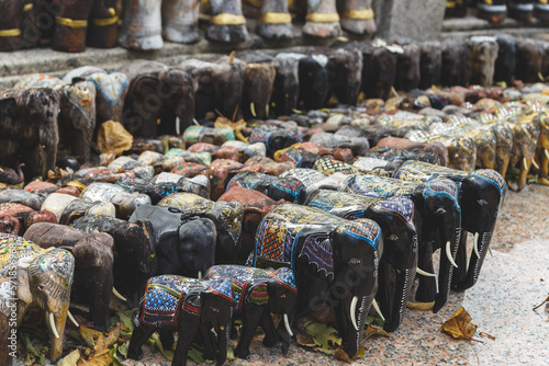 Canvas Print Many elephants statues.  The wood army of souvenir elephants.