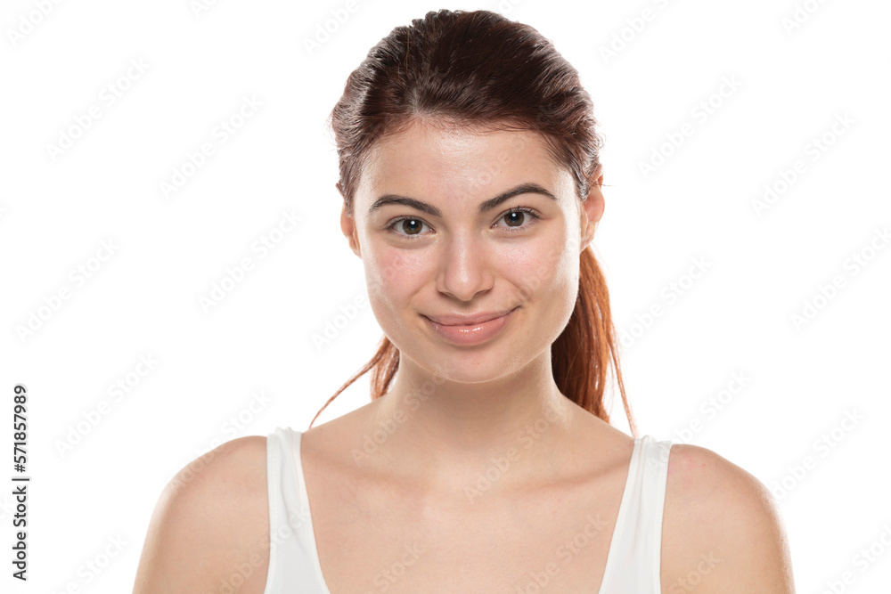 a young smiling redhead woman without makeup with long hair on a white background a young smiling redhead woman without makeup with long hair on a white background