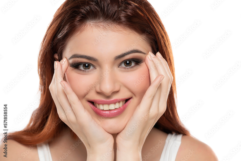 beautiful young smiling redhead women with makeup and long hair on a white background. beautiful young smiling redhead women with makeup and long hair on a white background.
