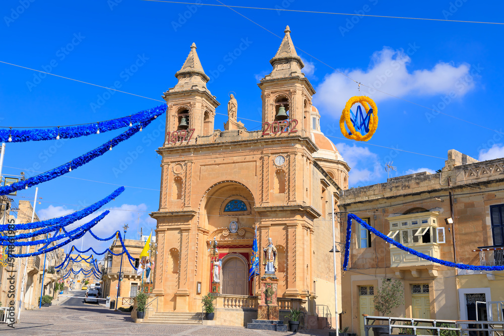 Urban view of Marsaxlokk, popular fishing village situated in the south-east end of the main island of Malta.Facade of the Parish Church of Our Lady of Pompei in Baroque style architecture.
