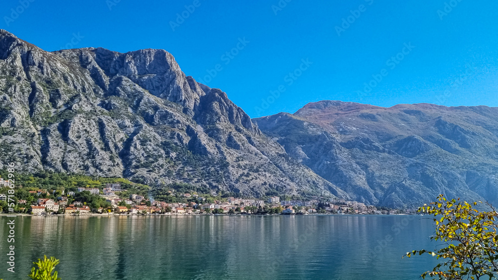 Scenic view on Kotor bay from idyllic coastal town Prcanj, Adriatic Mediterranean Sea, Montenegro, Balkans, Europe. Fjord winding along steep cliffs Dinaric Alps. Mountain peaks Gomile, Derinski Vrh