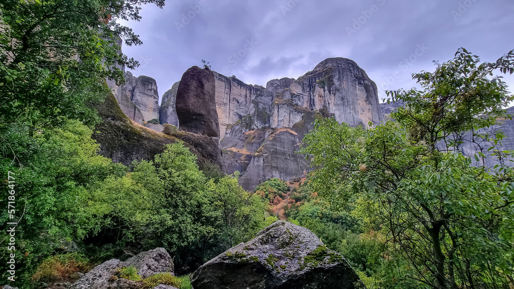 Scenic view of steep unique rock formation pinnacles overgrown with moss. Cloudy day in Kastraki, Kalambaka, Meteora, Thessaly, Greece, Europe. Avatar like dramatic landscape in mystical fog. Awe
