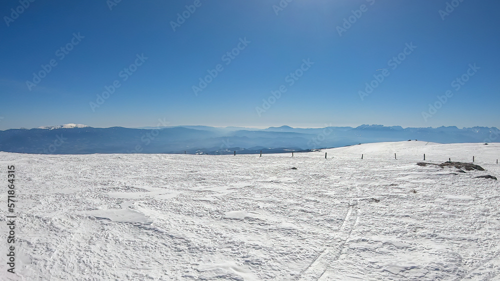 Scenic view of snow covered alpine meadows and Koralpe mountains seen from Ladinger Spitz, Saualpe, Lavanttal Alps, Carinthia, Austria, Europe. Untouched field of snow. Ski touring snowshoeing tourism