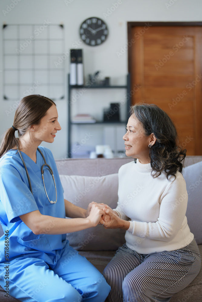 Fototapeta premium Portrait of a female doctor holding a patient's hand to encourage the fight against disease.