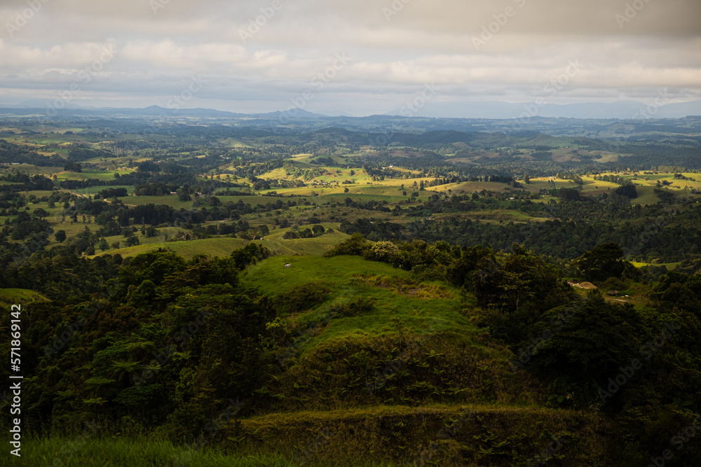 Lush Hilly view over a Valley With clouds rolling over Lush Hilly view over a Valley With clouds rolling over