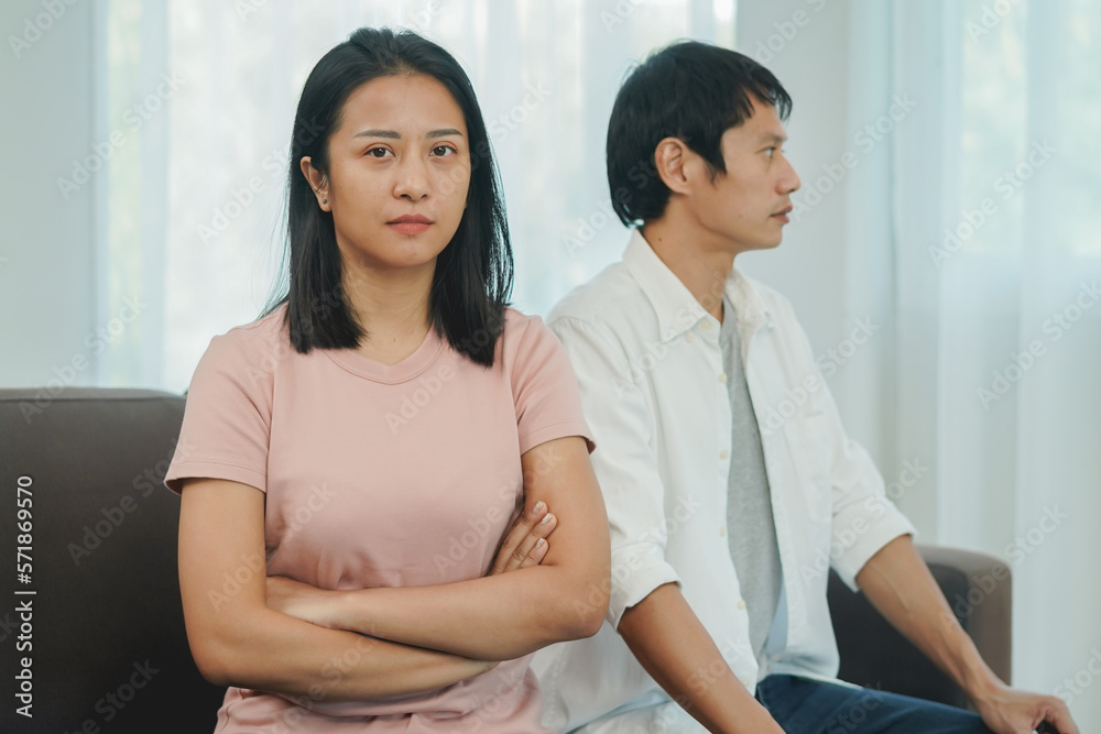 woman sitting back to back to his husband after quarrel at home woman sitting back to back to his husband after quarrel at home