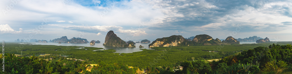 Top view on Phang nga bay. Samet Nangshe view point. High angle view of breathtaking limestone islands surrounding with emerald green water in blue sky summer. Panorama background.