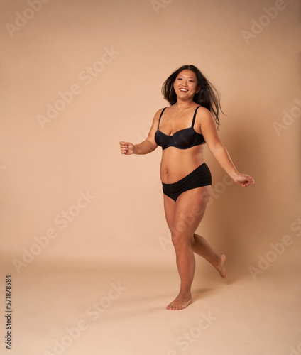 Cheerful Chinese woman in studio shot