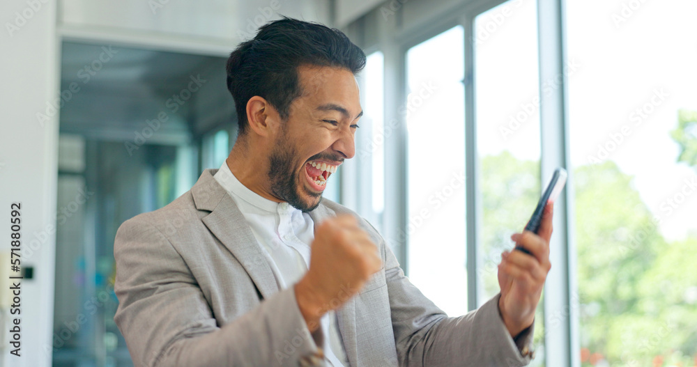 Success, phone and winner with businessman in office and celebration for deal, growth and stock market target. Wow, goals and good news with fist of employee for achievement, future and sale Success, phone and winner with businessman in office and celebration for deal, growth and stock market target. Wow, goals and good news with fist of employee for achievement, future and sale