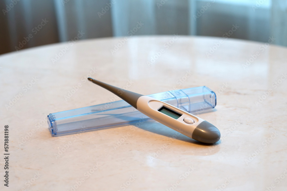 Electronic modern thermometer on white table Electronic modern thermometer on white table