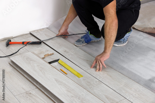 Man installing new laminate flooring indoors, closeup
