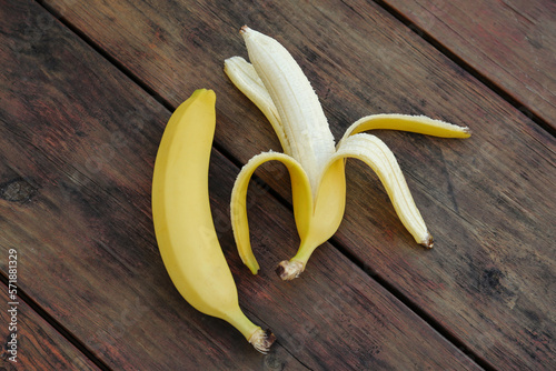 Delicious yellow bananas on wooden table, flat lay