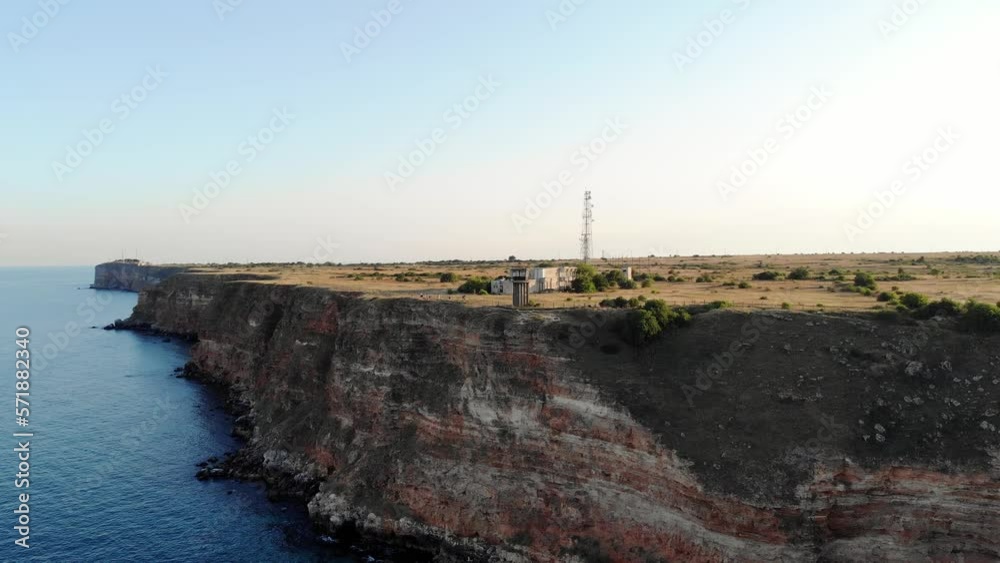Old Military Tower At Cape Kaliakra Near Bolata Beach Bay In Bulgaria. Aerial Pullback Shot Old Military Tower At Cape Kaliakra Near Bolata Beach Bay In Bulgaria. Aerial Pullback Shot
