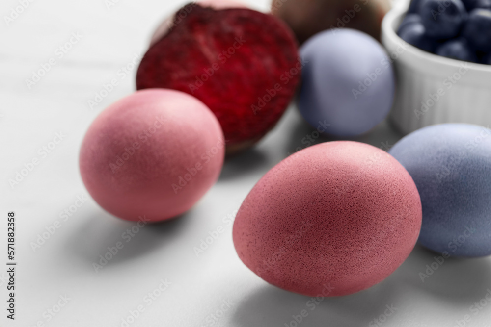 Colorful Easter eggs painted with natural dyes on white table, closeup Colorful Easter eggs painted with natural dyes on white table, closeup