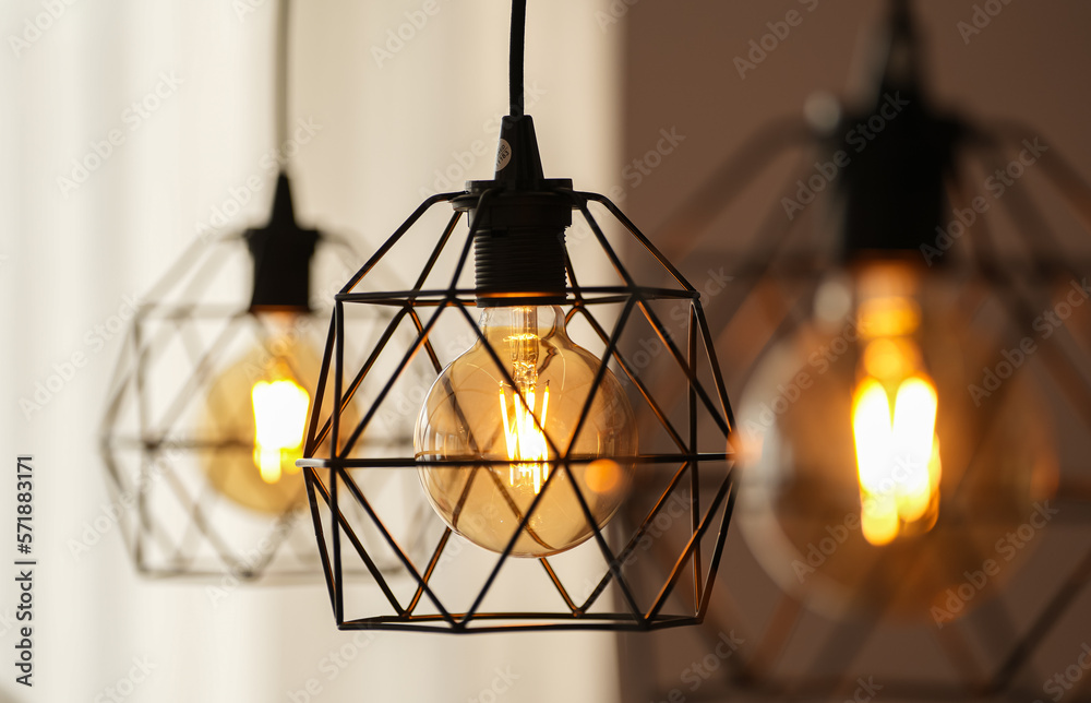 Decorative antique edison style light bulbs inside a modern apartment. Light inside the living room.