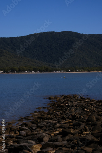 Waterfront view over the ocean in the tropics with a Clear blue sky and Christal clear water