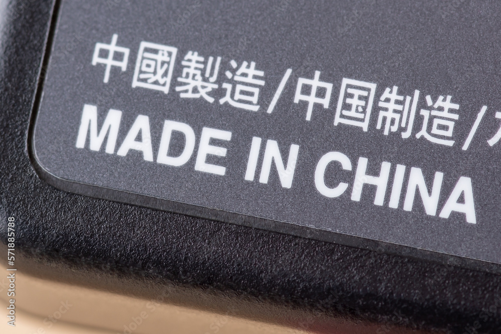 Fototapeta premium Close up shot of electric charger with inscription Made in China. Concept of production of electronics in China