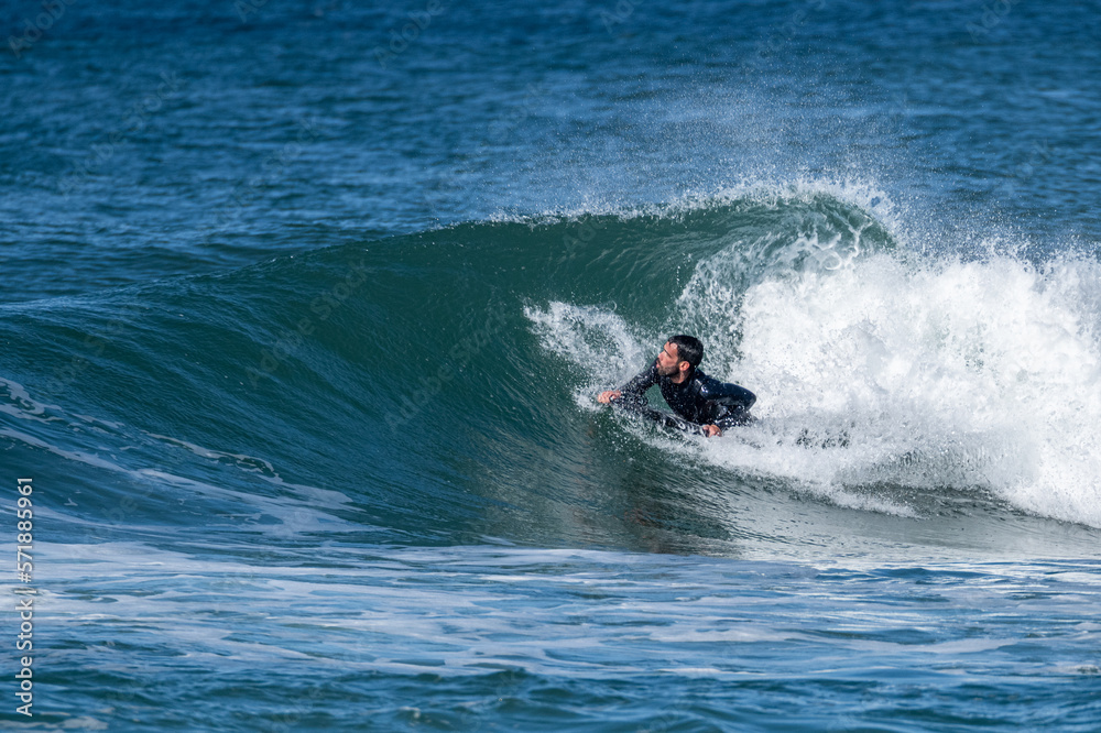 Bodyboarder surfing ocean wave