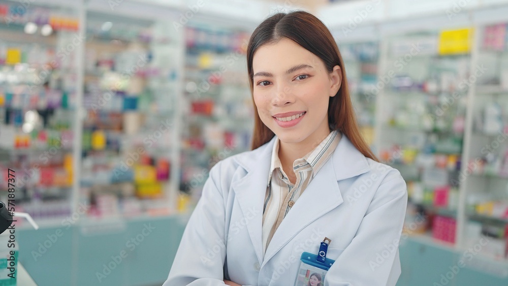 Smiling face of young professional asian woman pharmacist close up looking at camera in drugstore