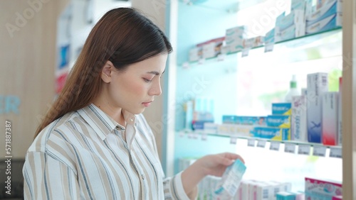 Beautiful young asian woman standing between shelves looking and shopping for medicine supplements products at pharmacy Free Download Beautiful young asian woman standing between shelves looking and shopping for medicine supplements products at pharmacy - GFXLoad