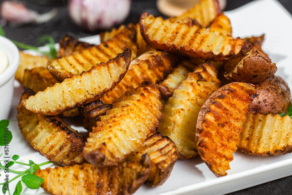 Baked potato slices on a dark background Baked potato slices on a dark background