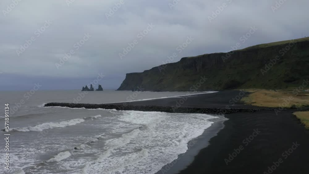 Aerial: Panoramic shot of Reynisfjara black sand beach in the southern coast of Vik in Iceland Aerial: Panoramic shot of Reynisfjara black sand beach in the southern coast of Vik in Iceland